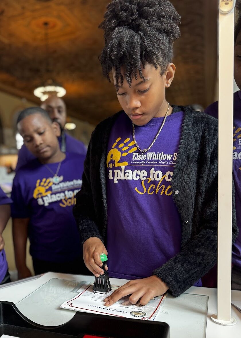 a girl stamps a document